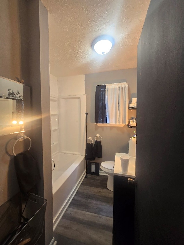 20 Patch Dr, Columbus, GA 31903 - bathroom with a textured ceiling, vanity, wood finished floors, and washtub / shower combination
