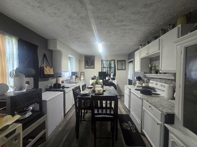 20 Patch Dr, Columbus, GA 31903 - kitchen with white range with electric stovetop, dark wood-style flooring, light countertops, white cabinetry, and fridge