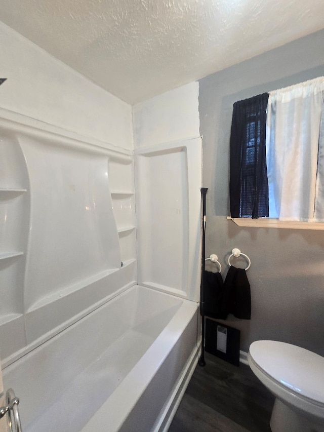 20 Patch Dr, Columbus, GA 31903 - full bathroom featuring wood finished floors, a textured ceiling, and washtub / shower combination