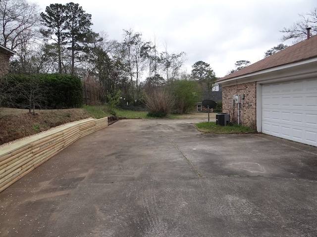 view of street featuring concrete driveway