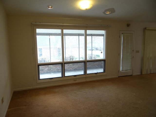 carpeted spare room with recessed lighting and baseboards