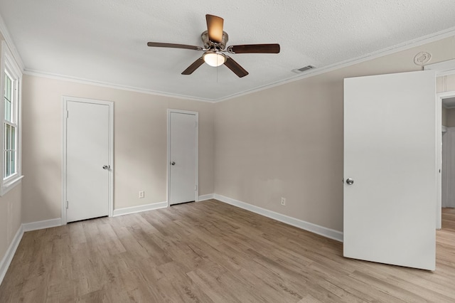 unfurnished bedroom with crown molding, visible vents, baseboards, and light wood-type flooring