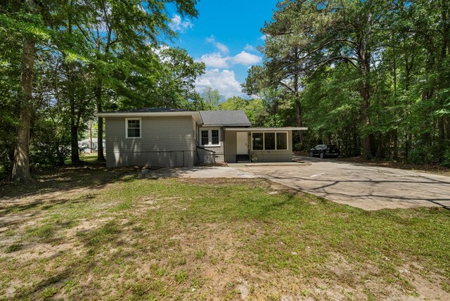 back of house featuring a yard and entry steps