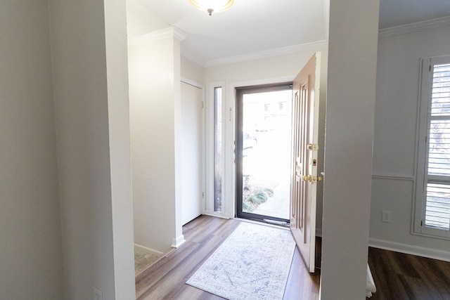 foyer entrance with ornamental molding and light hardwood / wood-style flooring