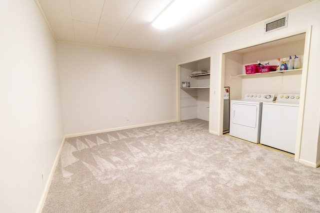 laundry area featuring light colored carpet and washer and dryer