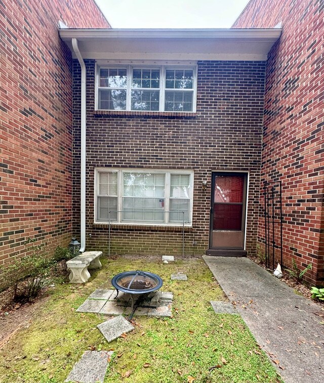 view of exterior entry featuring a yard