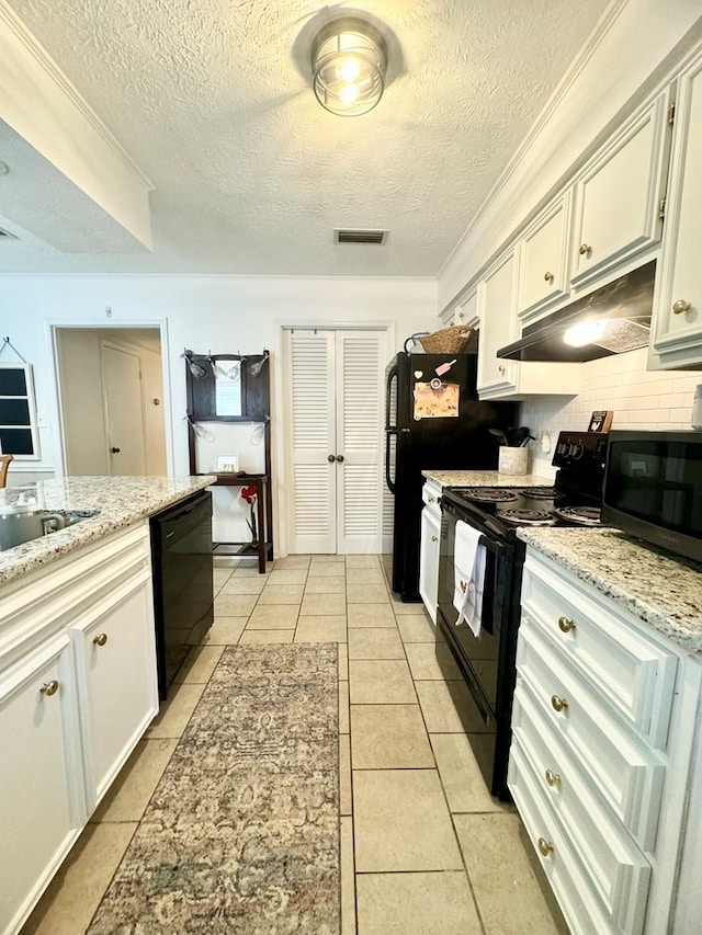 kitchen with white cabinets, a textured ceiling, tasteful backsplash, and black appliances