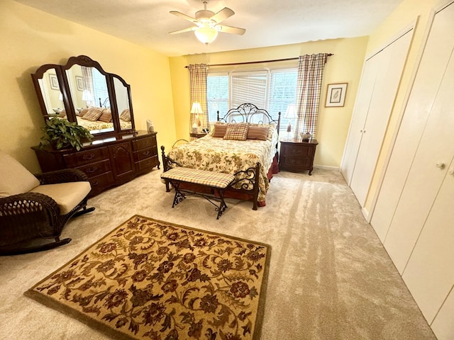 bedroom featuring ceiling fan and light carpet