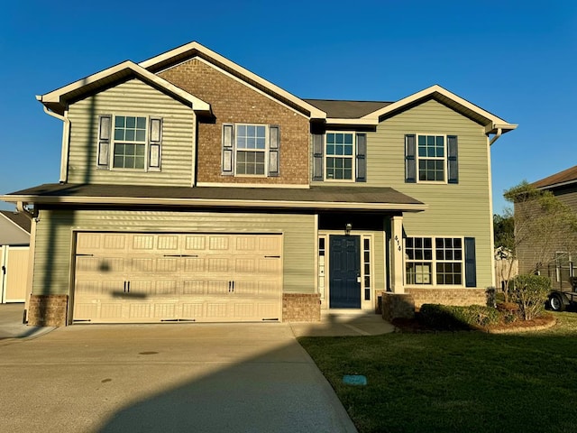 view of front of home featuring a garage and a front lawn