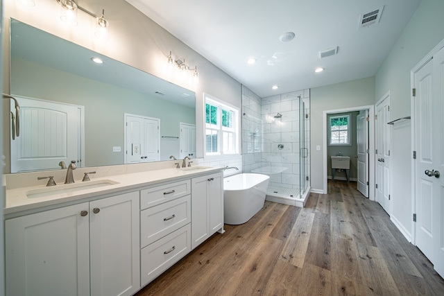 821 Lichfield Rd, Columbus, GA 31904 - full bath with a stall shower, double vanity, a freestanding bath, wood finished floors, and recessed lighting