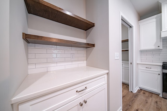 821 Lichfield Rd, Columbus, GA 31904 - kitchen featuring open shelves, decorative backsplash, white cabinetry, light wood-style flooring, and stainless steel electric range oven