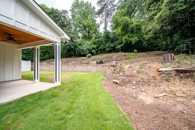821 Lichfield Rd, Columbus, GA 31904 - view of green lawn featuring a ceiling fan, a patio area, and view of wooded area