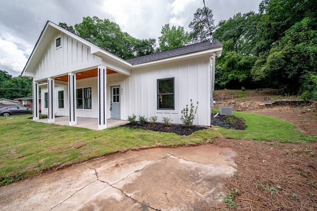 821 Lichfield Rd, Columbus, GA 31904 - view of front facade with board and batten siding, a front yard, a patio area, and a shingled roof