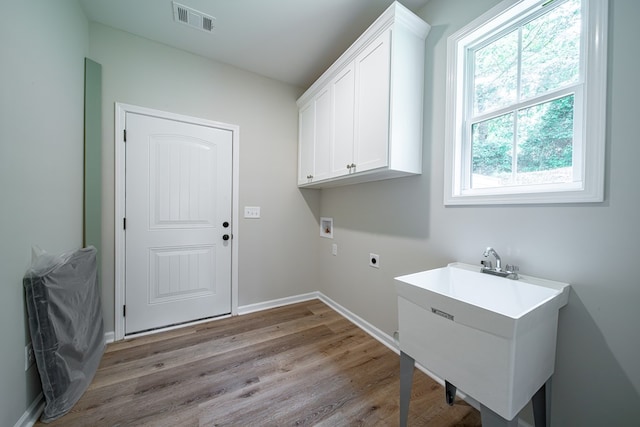 821 Lichfield Rd, Columbus, GA 31904 - laundry room with hookup for a washing machine, healthy amount of natural light, light wood-type flooring, and hookup for an electric dryer