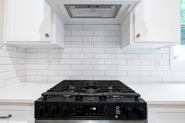 821 Lichfield Rd, Columbus, GA 31904 - kitchen with gas range, ventilation hood, white cabinetry, decorative backsplash, and light stone countertops