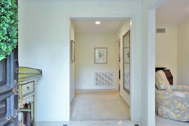 hall featuring crown molding, carpet flooring, baseboards, and visible vents