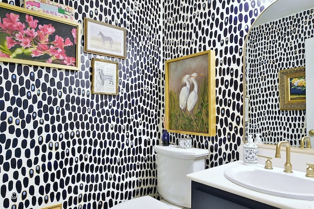 7124 Leighton Rd, Columbus, GA 31904 - half bath featuring toilet, vanity, and wallpapered walls