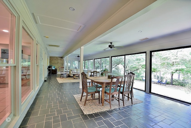 sunroom / solarium with a ceiling fan, outdoor dining space, and visible vents