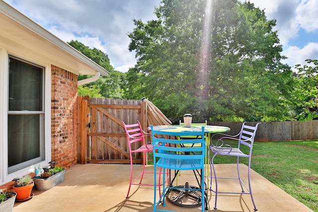 view of patio / terrace with fence and a gate