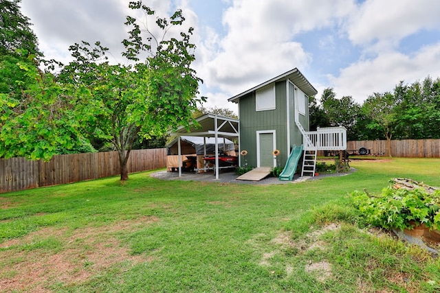 rear view of property featuring a fenced backyard and a yard