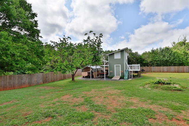 view of yard with a fenced backyard and a deck