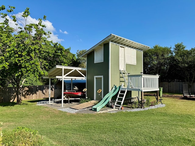 view of jungle gym featuring fence and a yard
