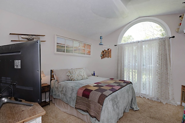 carpeted bedroom with vaulted ceiling