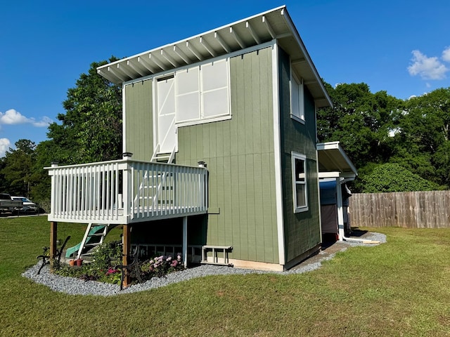 back of house with a yard, fence, and a wooden deck