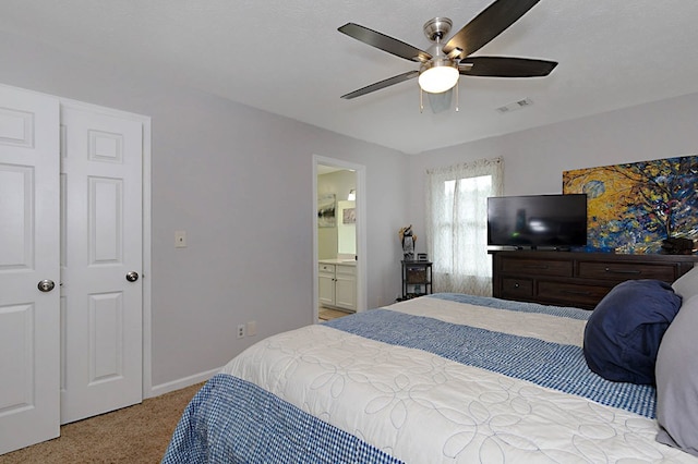 carpeted bedroom featuring connected bathroom, ceiling fan, visible vents, and baseboards