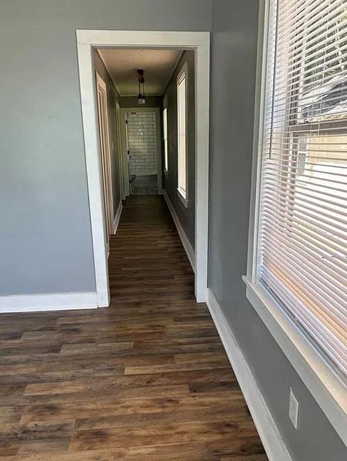 hallway with dark wood-type flooring