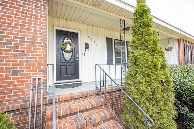 entrance to property with brick siding