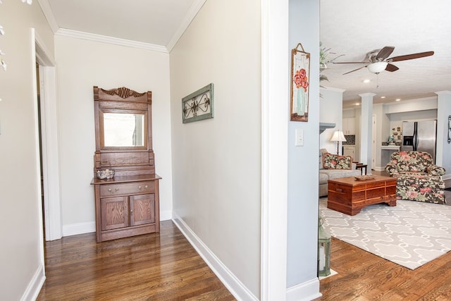 corridor featuring recessed lighting, crown molding, baseboards, and wood finished floors