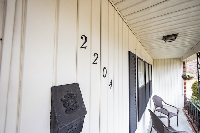 property entrance featuring board and batten siding