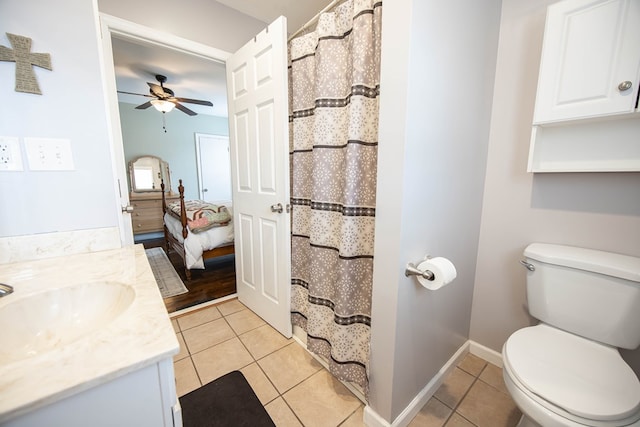 ensuite bathroom featuring ceiling fan, tile patterned flooring, toilet, connected bathroom, and vanity