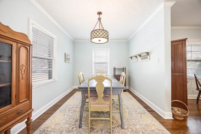 dining space featuring a textured ceiling, ornamental molding, dark wood-style flooring, and baseboards