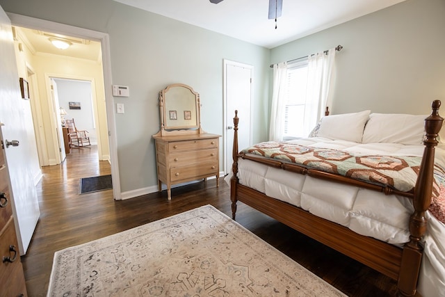 bedroom featuring dark wood-style floors, ceiling fan, and baseboards