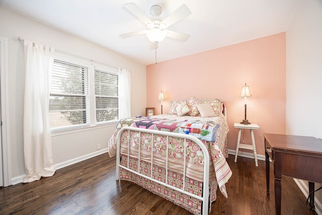 bedroom with ceiling fan, wood finished floors, and baseboards