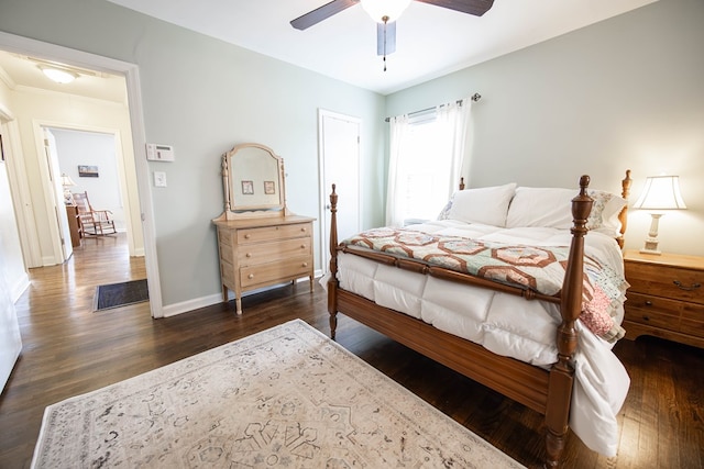 bedroom featuring ceiling fan, dark wood finished floors, and baseboards