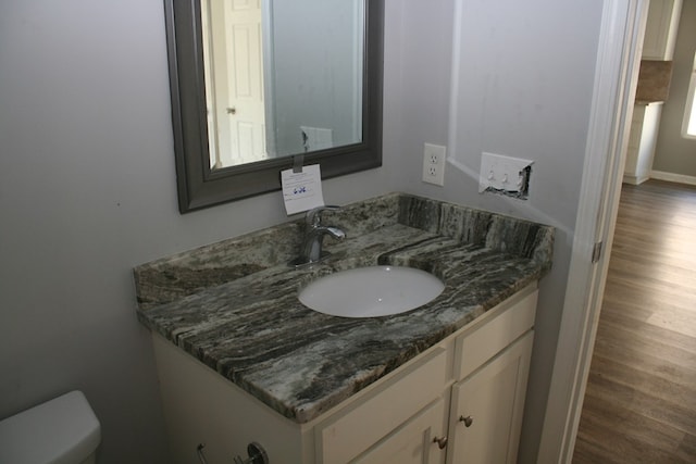 3813 Meritas Dr, Columbus, GA 31904 - half bathroom with vanity and wood finished floors