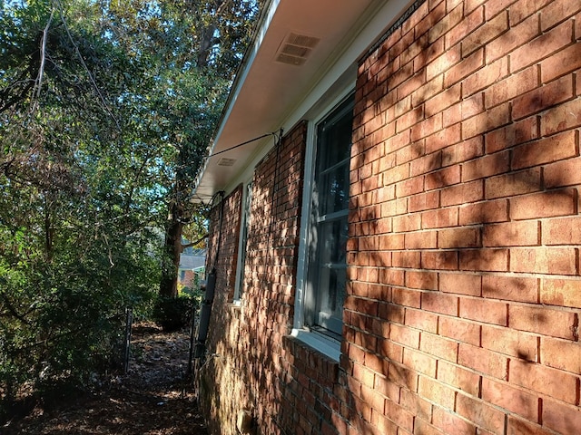 view of side of property with brick siding