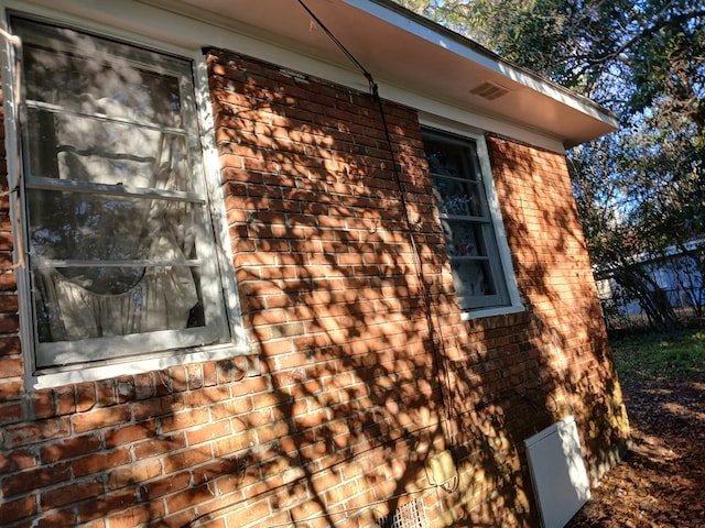 view of side of home featuring brick siding