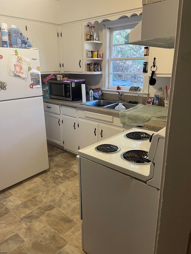 kitchen with white appliances, white cabinets, under cabinet range hood, and a sink