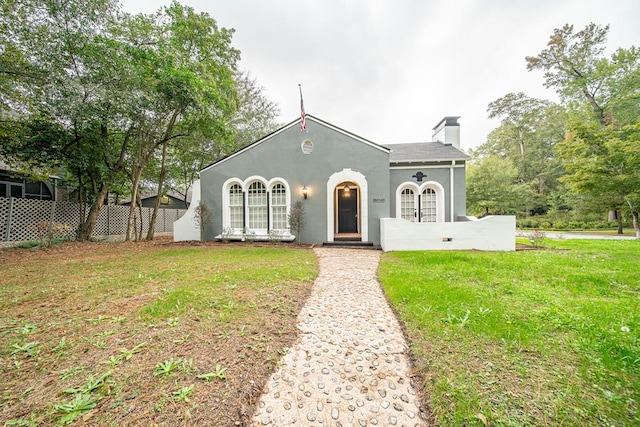 mediterranean / spanish house featuring a front lawn