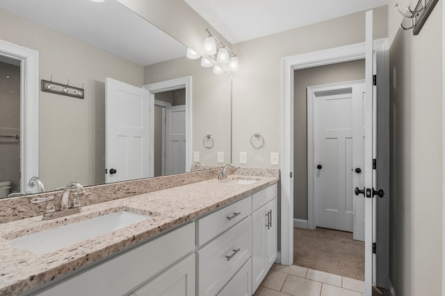 bathroom with double vanity, a sink, and tile patterned floors