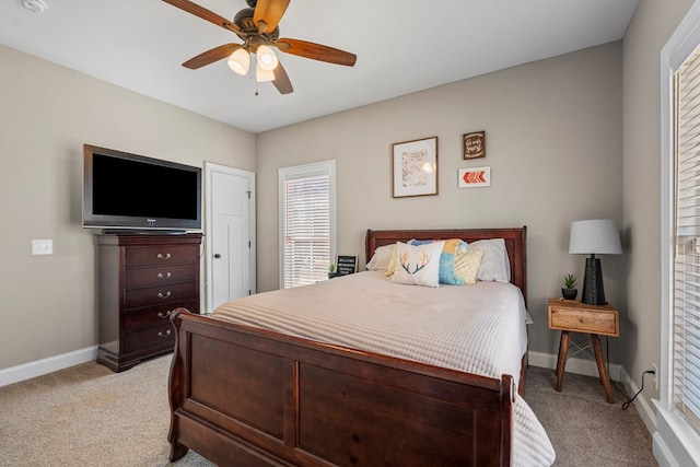 bedroom with light carpet, ceiling fan, and baseboards