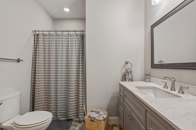 full bath with curtained shower, vanity, toilet, and baseboards