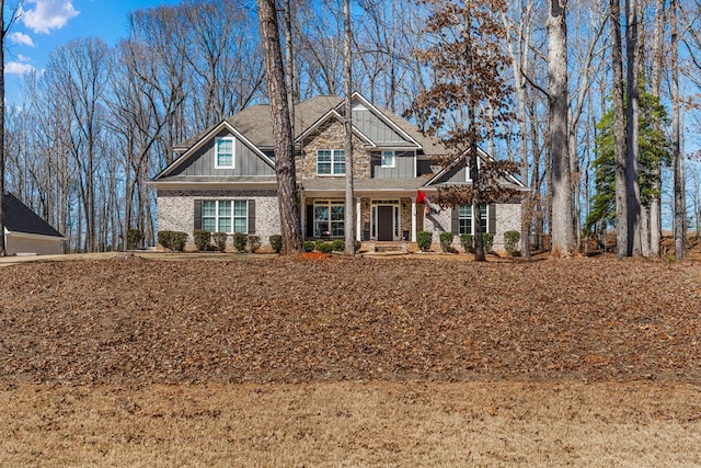 craftsman-style home featuring brick siding and board and batten siding