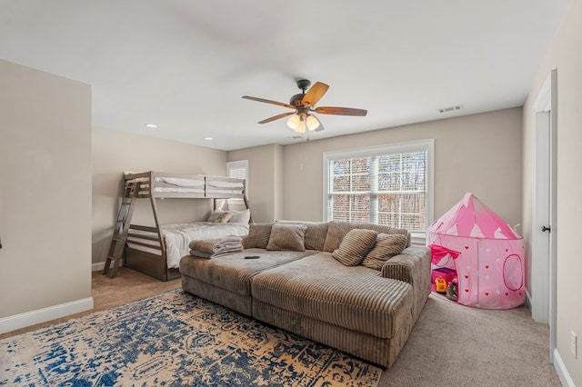 bedroom with carpet floors, visible vents, baseboards, and a ceiling fan