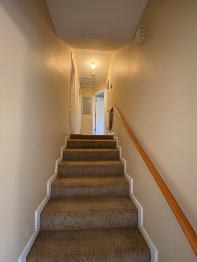 staircase featuring electric panel