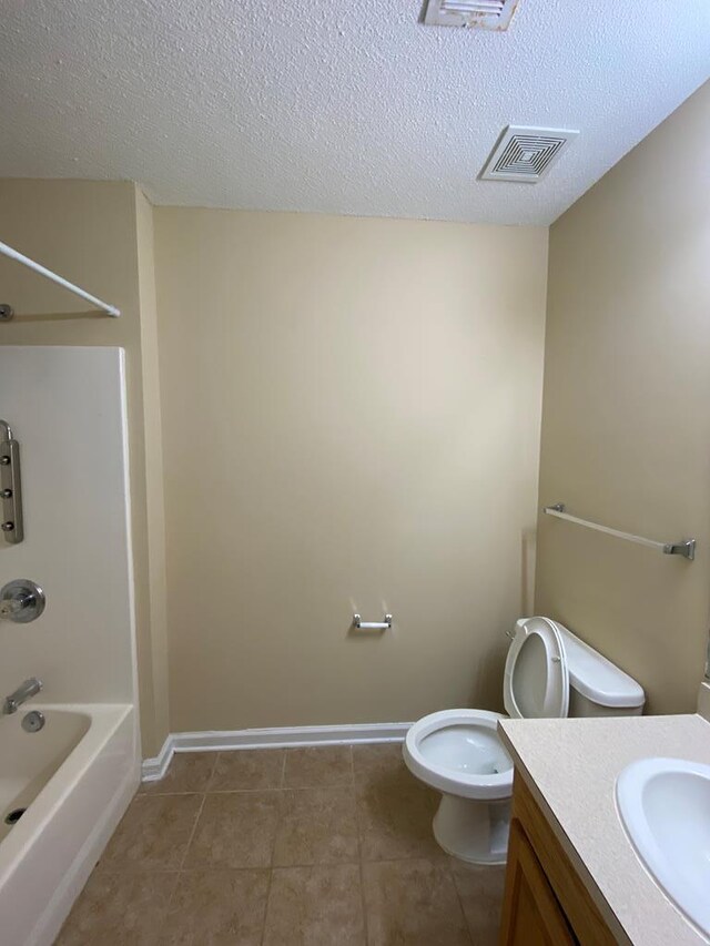 full bathroom featuring tile patterned floors, tub / shower combination, vanity, a textured ceiling, and toilet